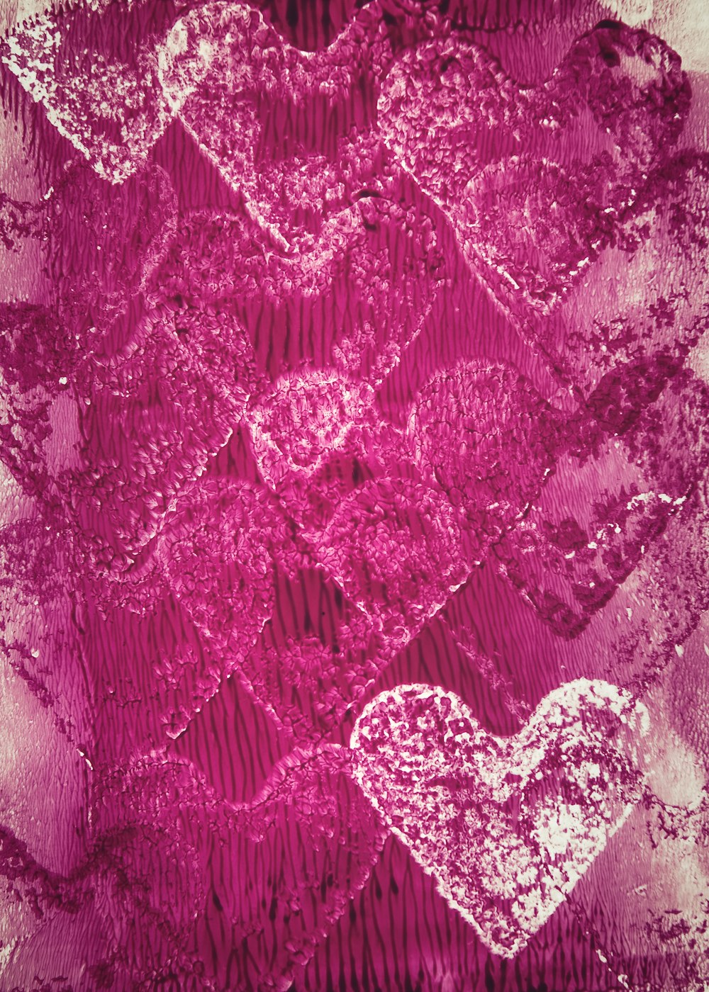 two hearts are shown on a pink background