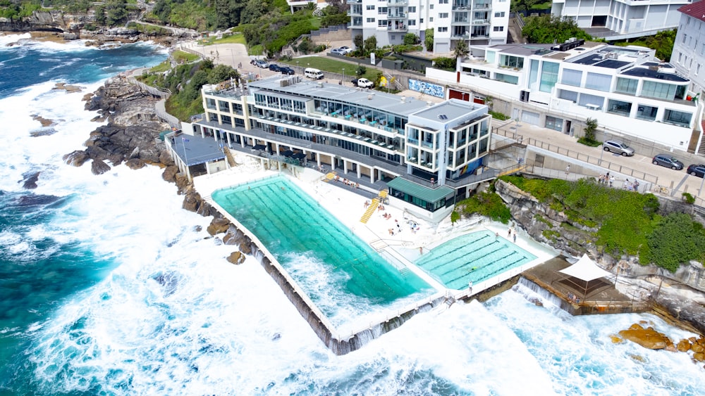 an aerial view of a large building next to the ocean
