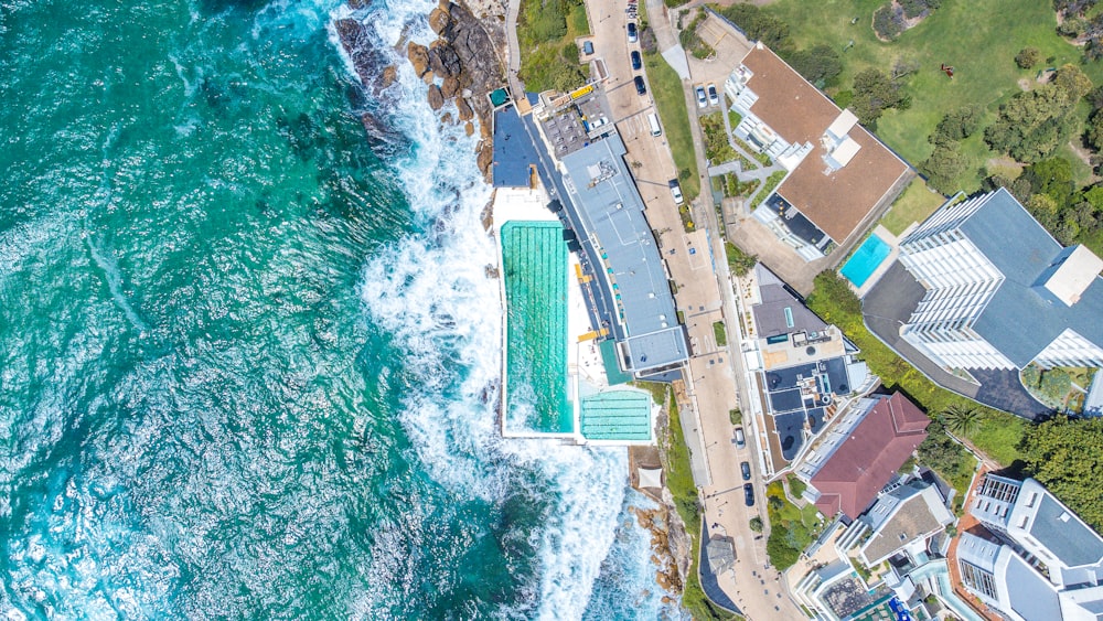 an aerial view of the ocean and houses