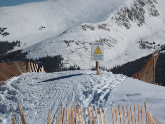 Sunlit snow-covered Australian wilderness with clear signage for safe paths.