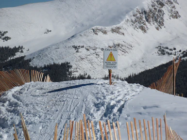 Sunlit snow-covered Australian wilderness with clear signage for safe paths.