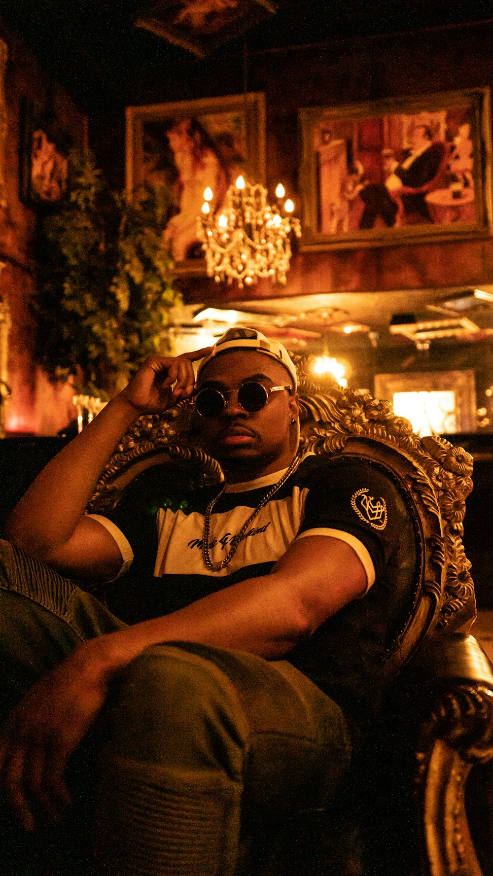 a man sitting on top of a chair in a room