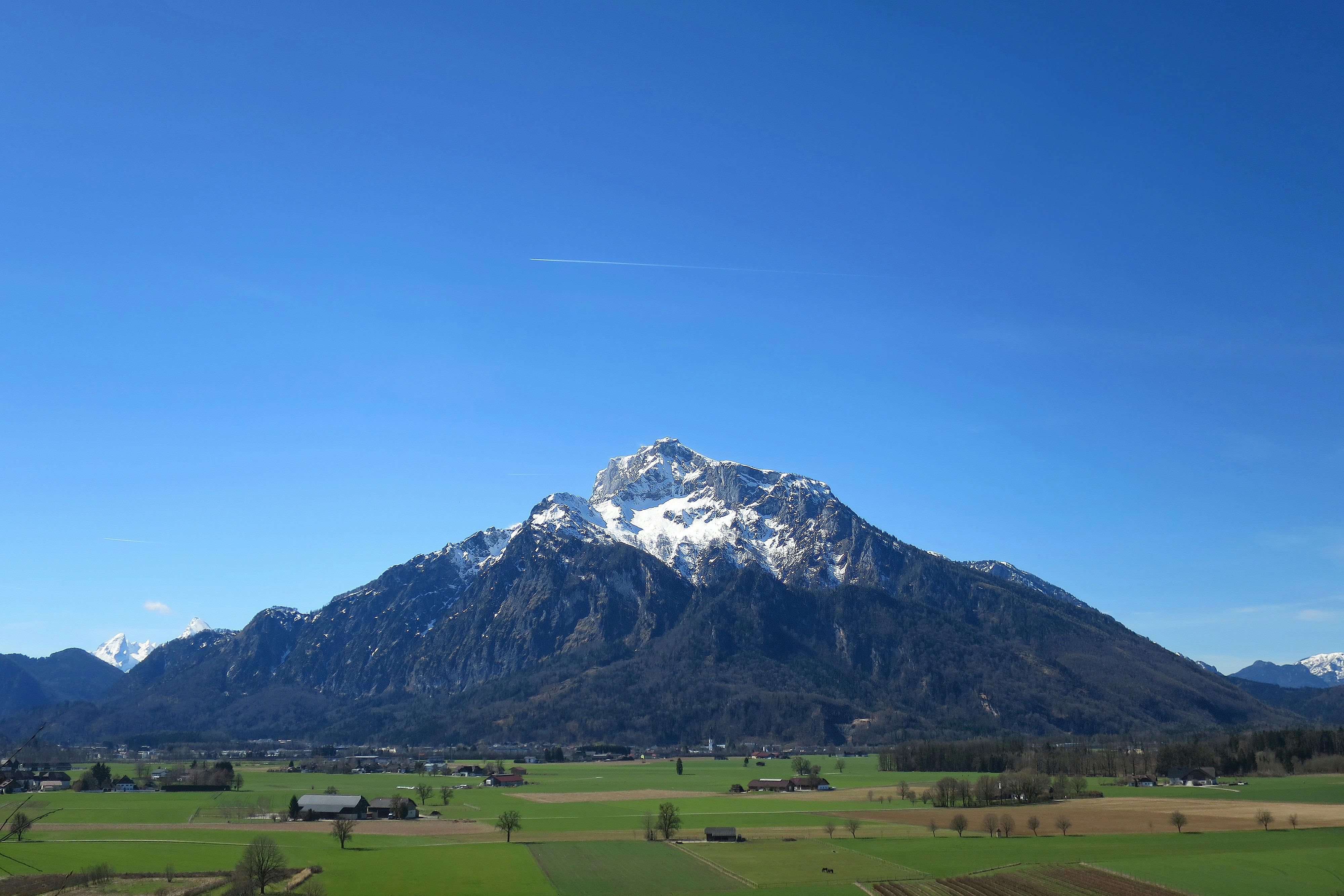 a view of a large mountain with snow on it
