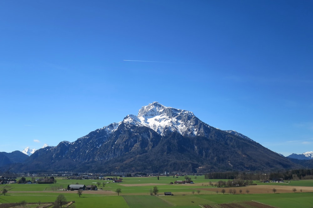 a view of a large mountain with snow on it