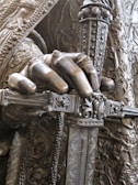 a close up of a statue of a person holding a sword