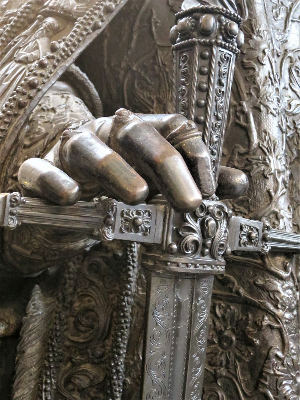 a close up of a statue of a person holding a sword