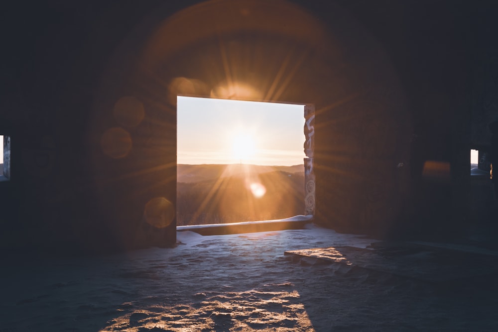 the sun is shining through an open doorway