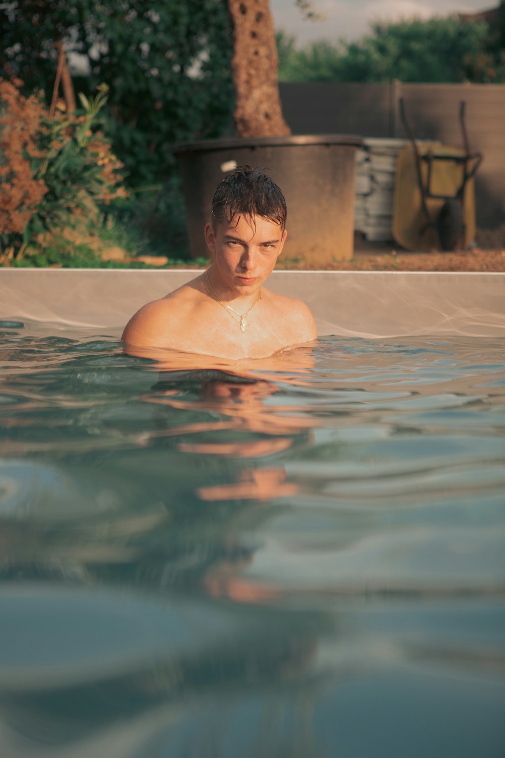 a man in a swimming pool with no shirt on