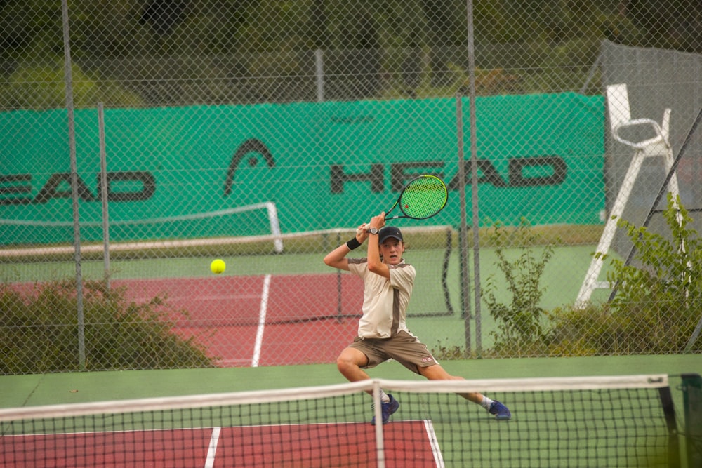 a man swinging a tennis racquet on a tennis court