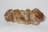 A loaf of braided bread with a golden-brown crust and a dusting of flour on its surface, placed on a plain white background.