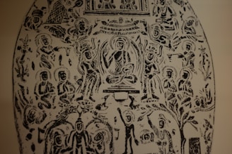 An intricate black and white etching featuring numerous human figures in various seated and standing positions. The central figure appears to be sitting cross-legged, surrounded by an aura, with others arranged symmetrically around them. The figures are stylized and have halos around their heads. Ornate patterns and what appear to be nature elements are interspersed throughout the design.