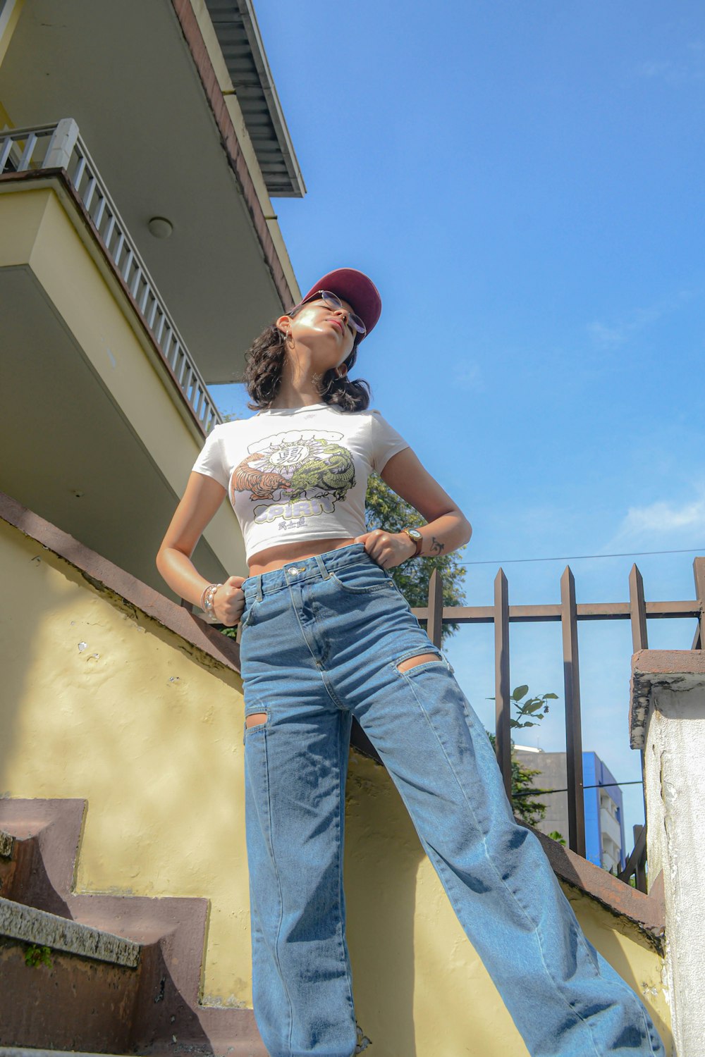 a woman standing on the steps of a building