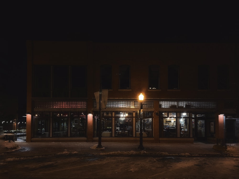 a dark street at night with a building lit up