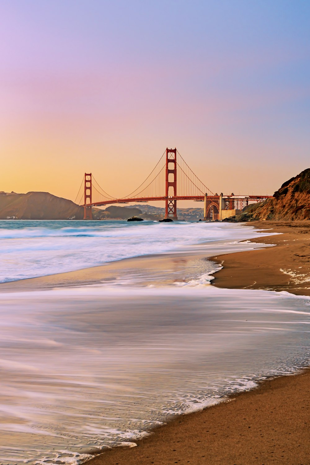 a view of the golden gate bridge from the beach