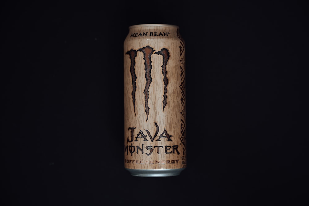 a can of monster energy drink on a black background