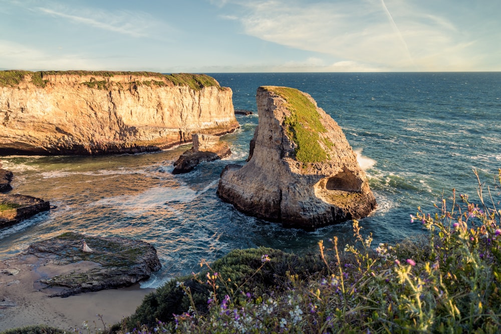 a rocky cliff overlooks a body of water