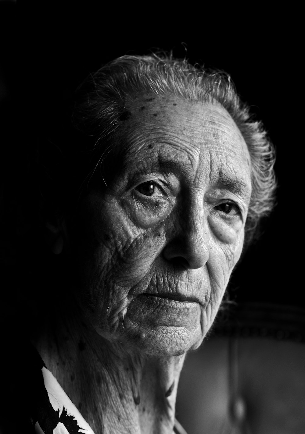 a black and white photo of an old woman