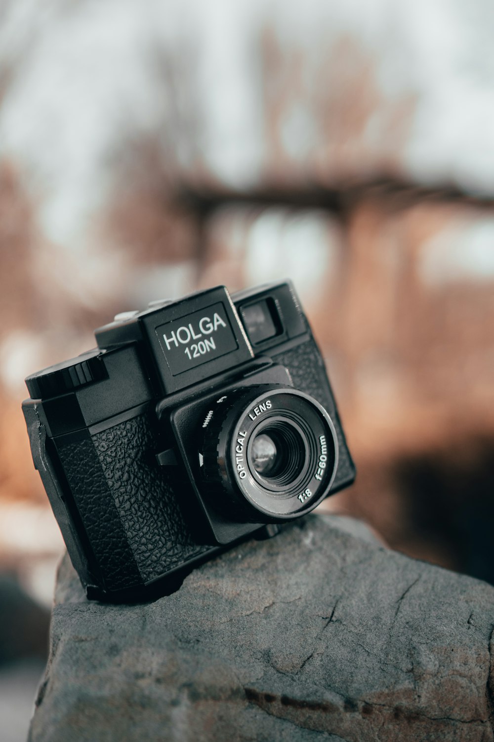 a camera sitting on top of a rock