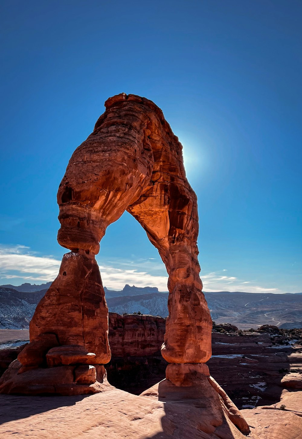 a large rock arch in the middle of a desert