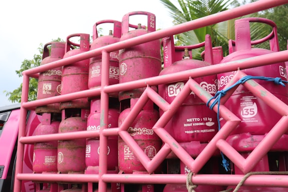 Image of LPG gas cylinders being loaded for distribution at a warehouse.