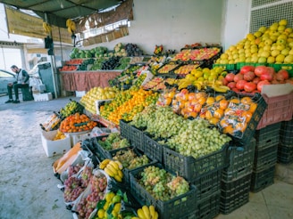 a fruit stand with lots of fruits and vegetables