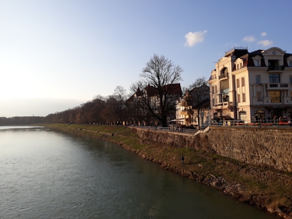 A serene view of the ghats along the Ganges River in Varanasi during sunrise.