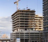 a building under construction with a crane in the background