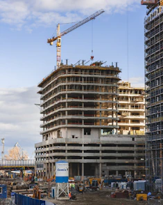 a building under construction with a crane in the background