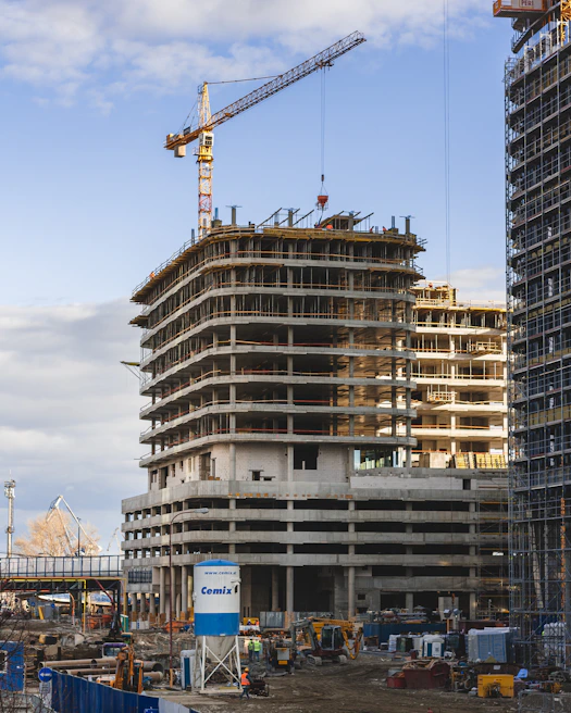 a building under construction with a crane in the background