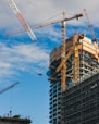 a large building under construction next to a crane