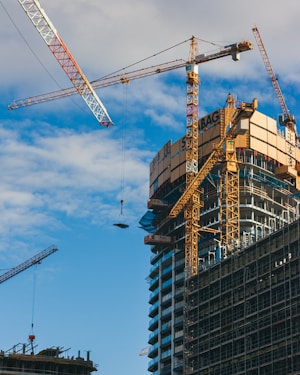 a large building under construction next to a crane