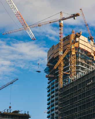a large building under construction next to a crane