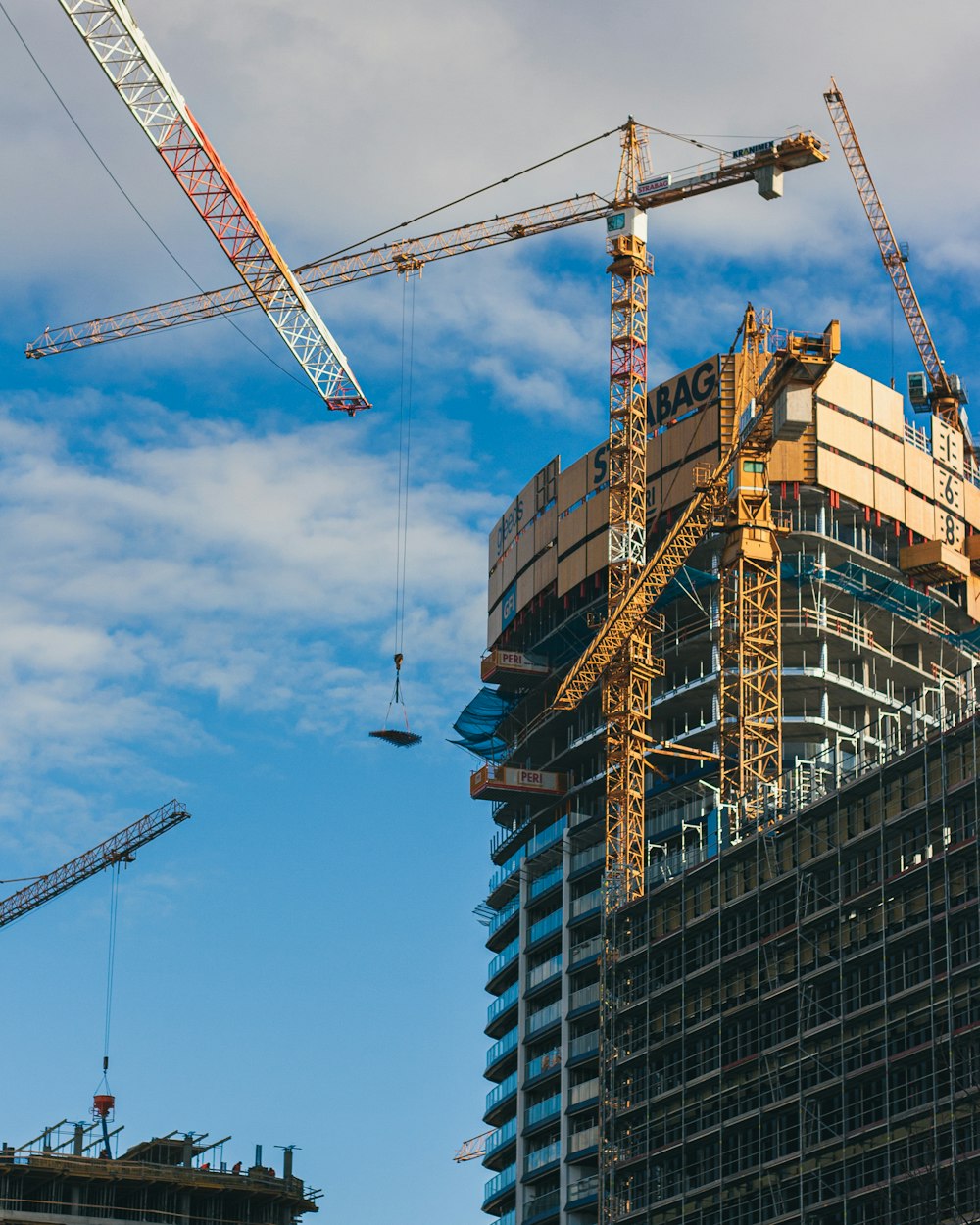 a large building under construction next to a crane