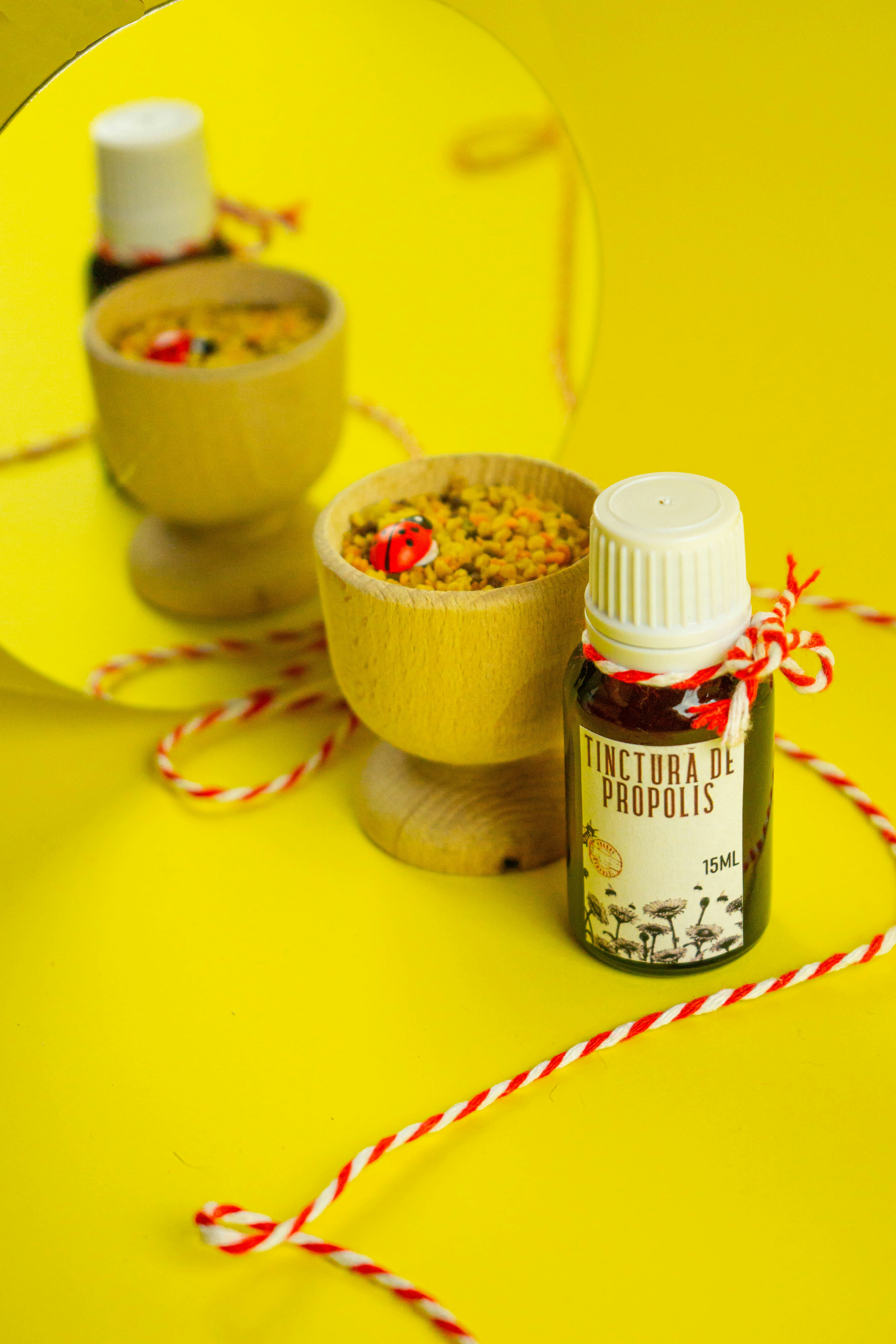 a bowl of food next to a bottle of liquid