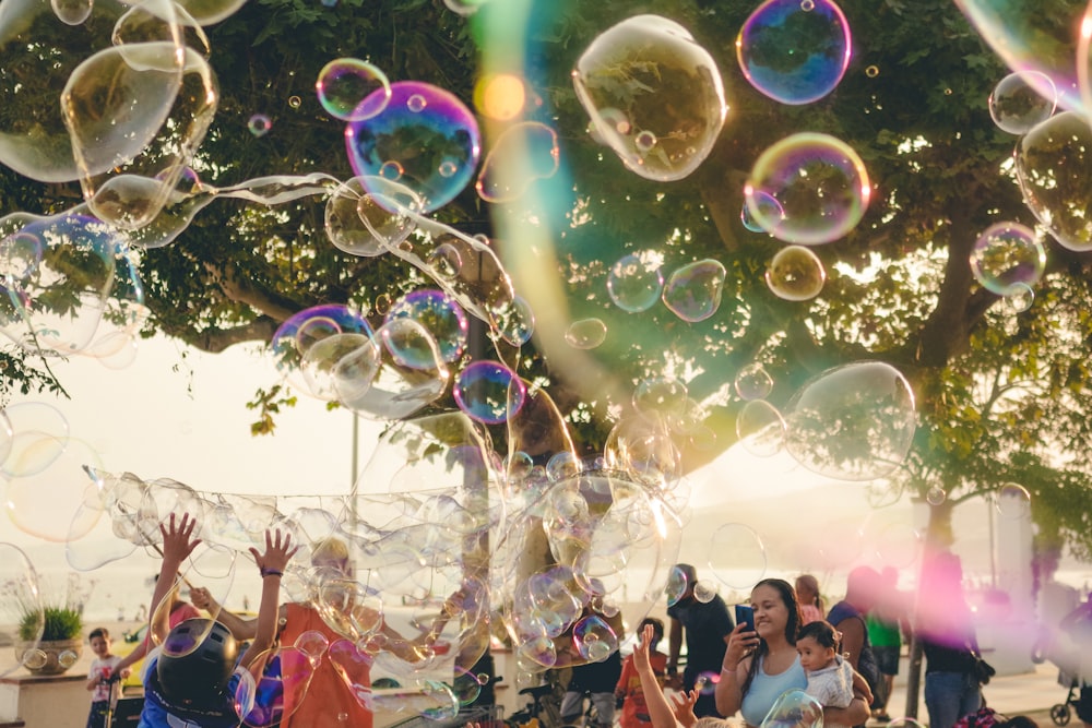 a group of people are blowing soap bubbles