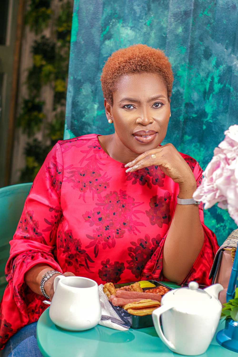 a woman sitting at a table with a plate of food