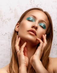 a woman with blue eyeshades posing for a picture