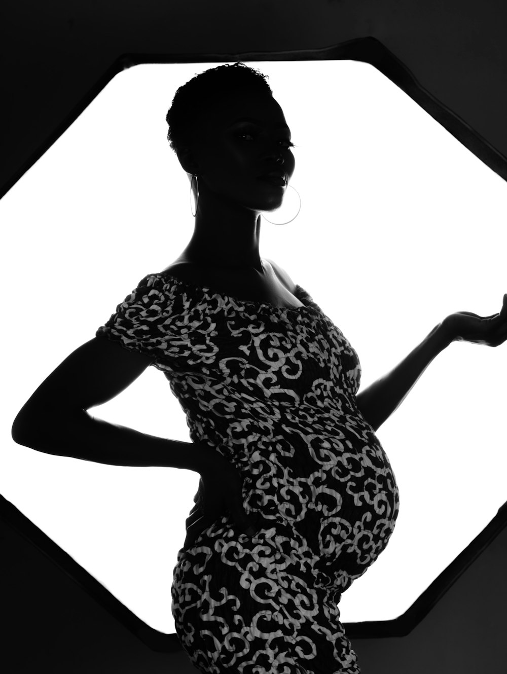 a pregnant woman in a black and white photo