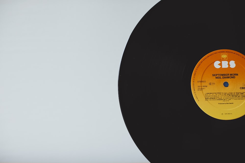 a black record with an orange label on it