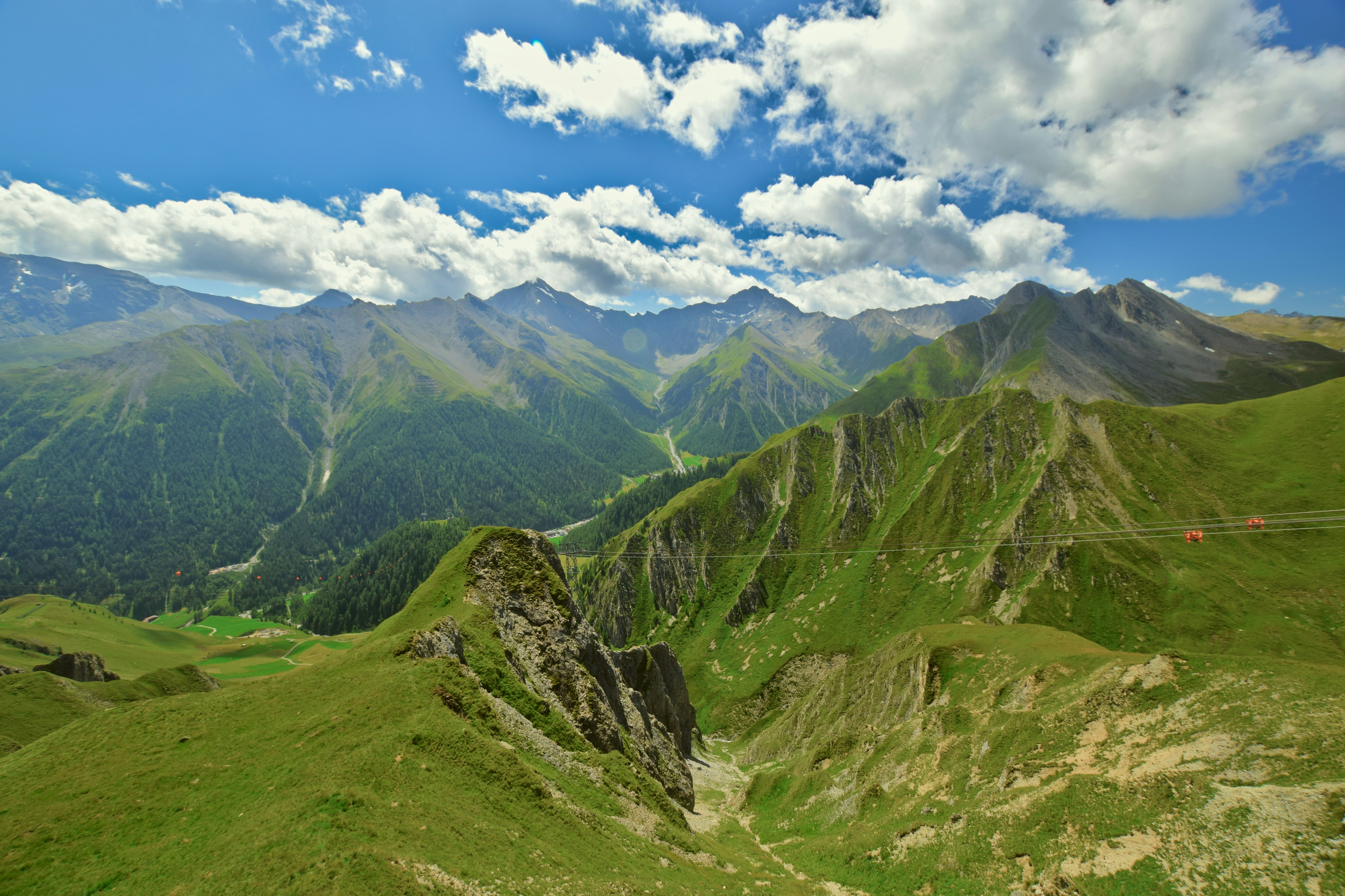 a scenic view of a mountain range with a rope in the foreground
