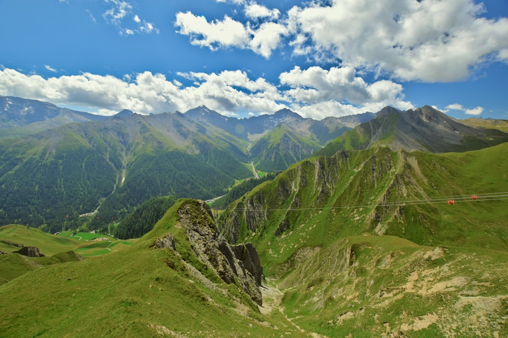 a scenic view of a mountain range with a rope in the foreground