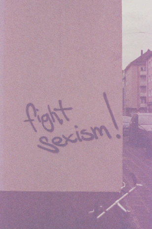 a sign that says fight sexism on it