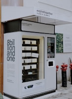 a vending machine sitting on the side of a building