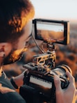a man holding a camera and recording something