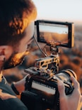 a man holding a camera and recording something