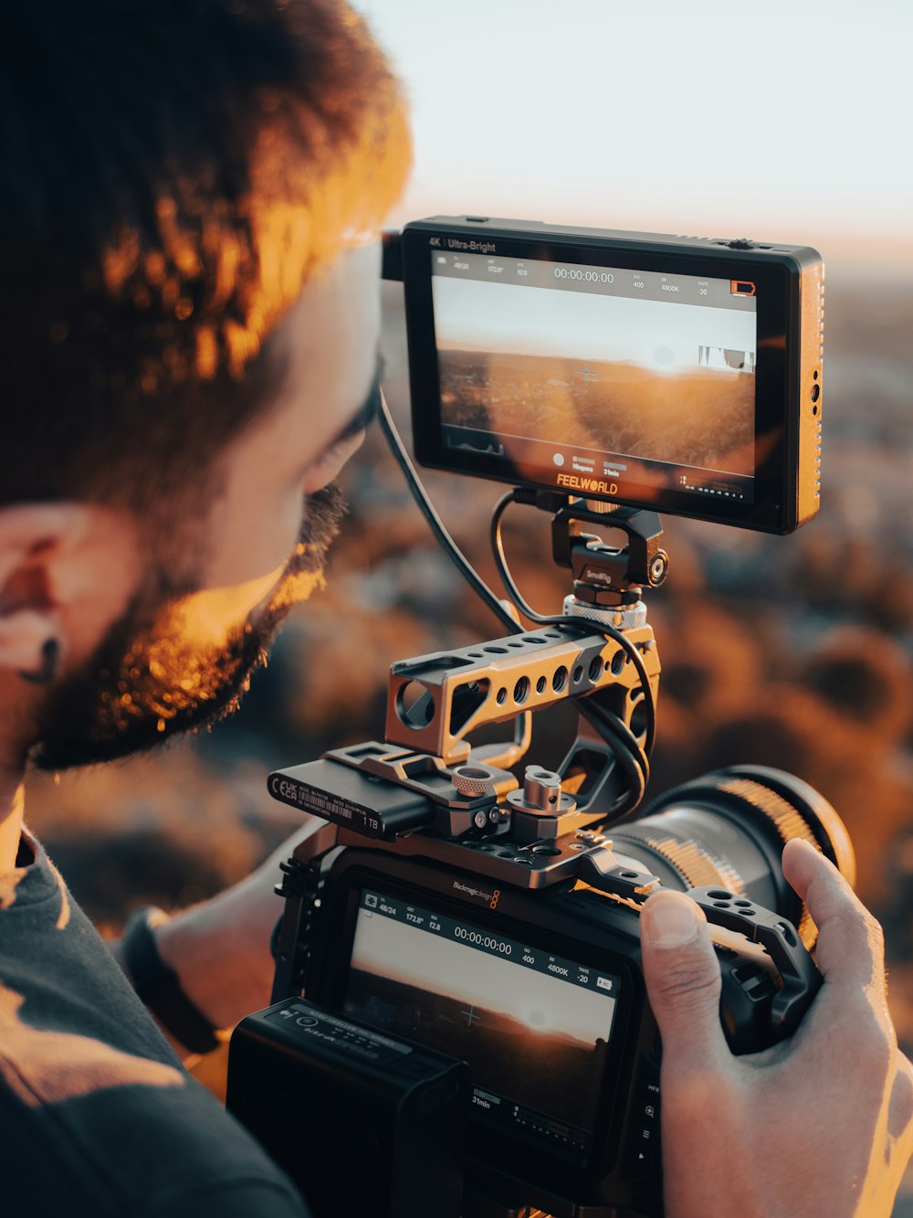 a man holding a camera and recording something