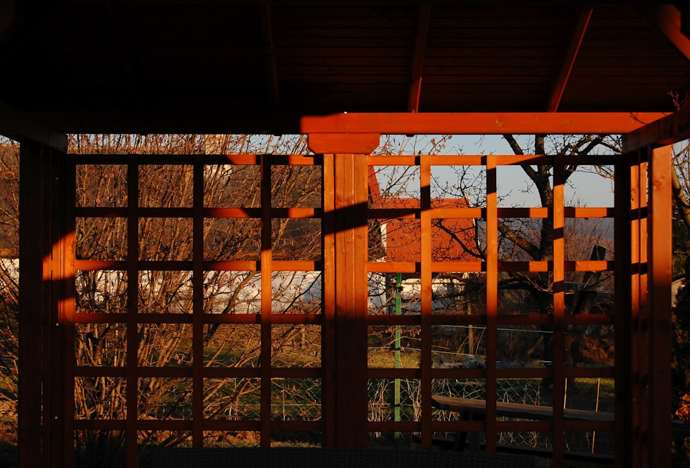 a wooden structure with a bench in front of it