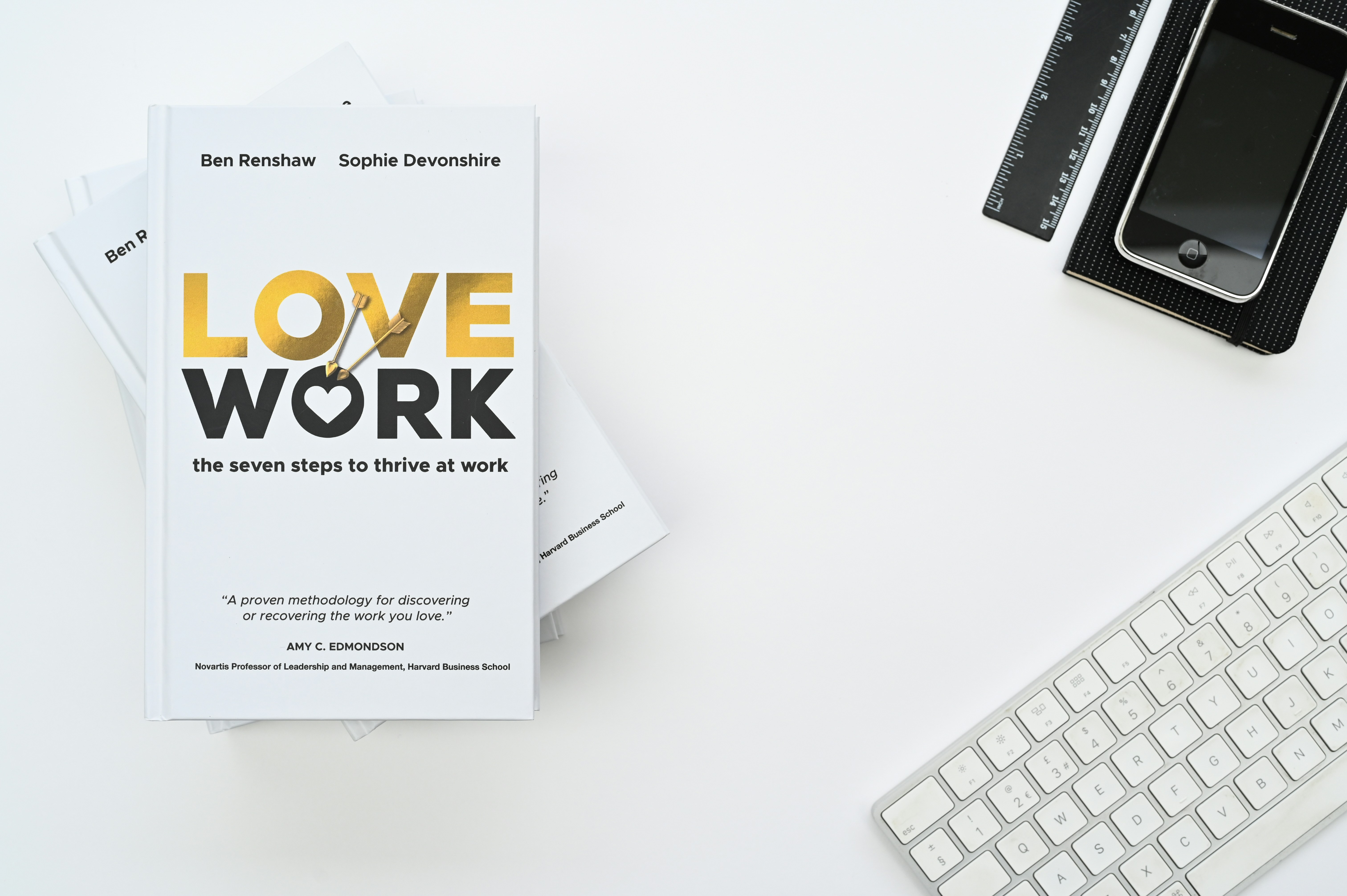 a book sitting on top of a table next to a keyboard