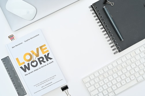 a book sitting on top of a desk next to a keyboard