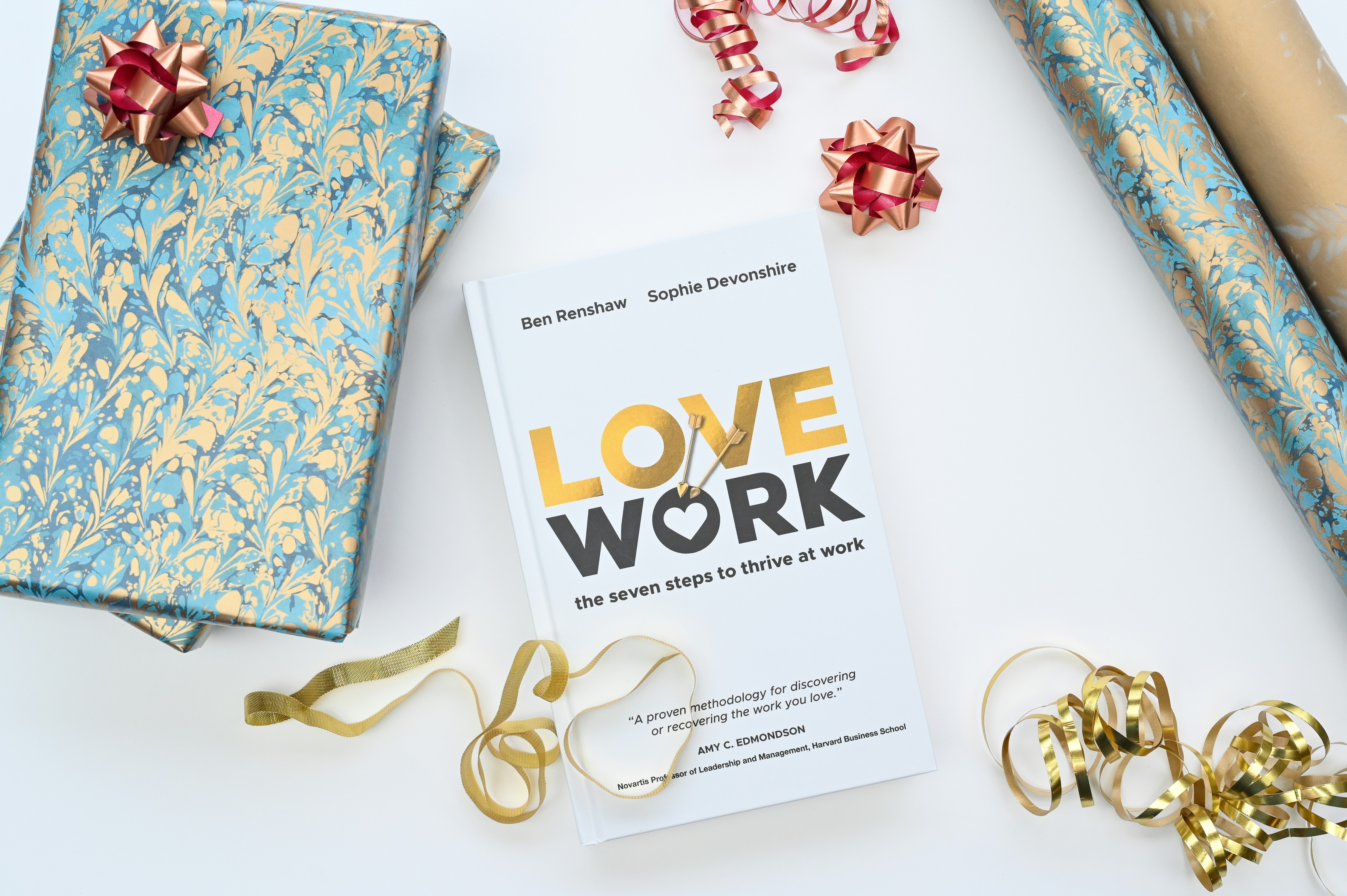 a book on love work surrounded by wrapping paper